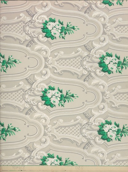 A repetative lacy pattern with intermittent depictions of whiteflowers with greenery.